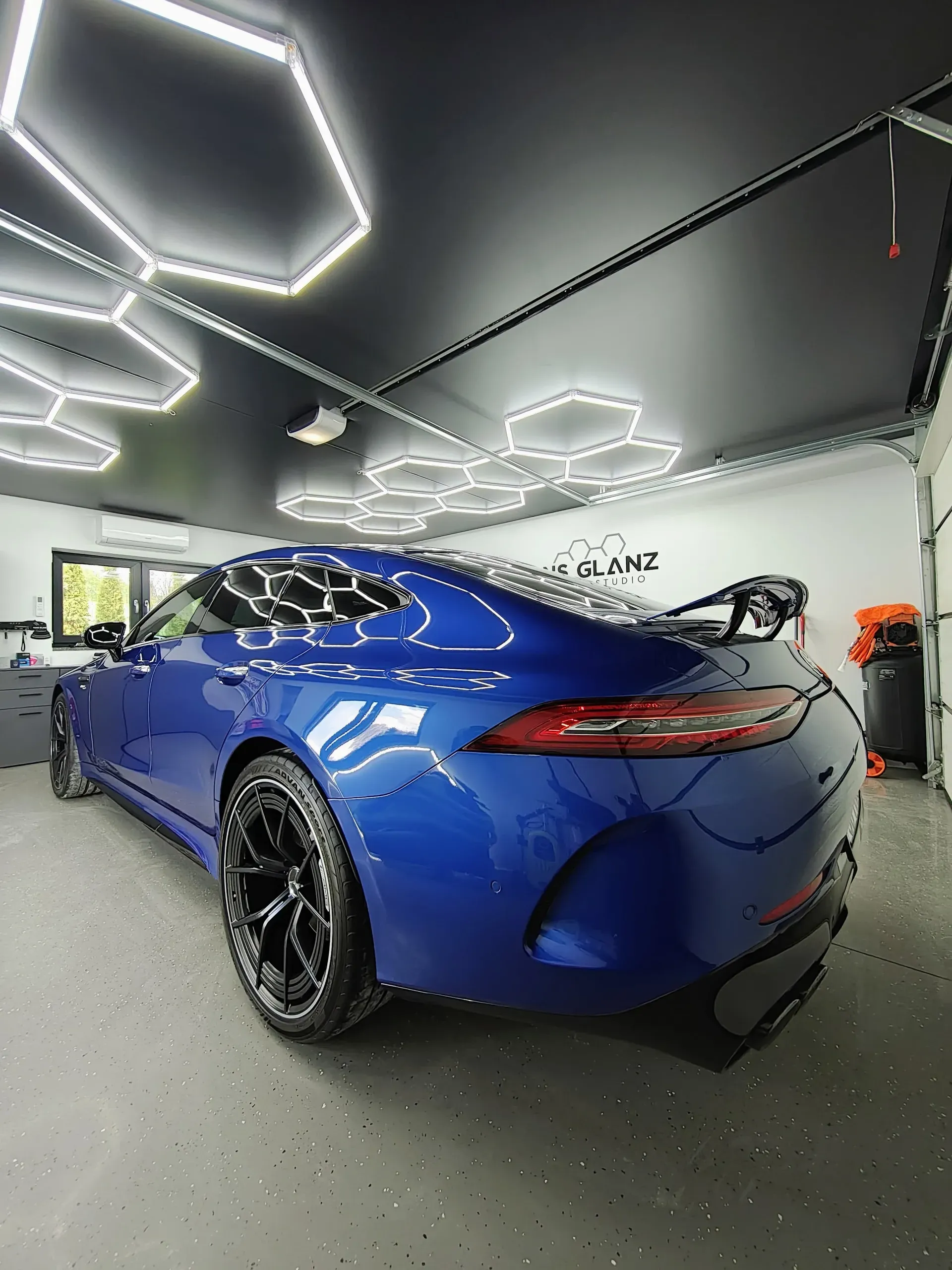 Pomarańczowy BMW M w studio Hans Glanz pod neonowymi heksami